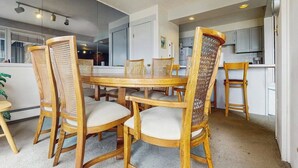 A dining area with a round table and six wicker chairs with cushioned seats. - Mountain & lake views from this Lake Cliffe condo - clubhouse access (Dillon)