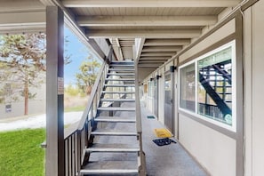 A covered outdoor staircase leading to a building entrance.