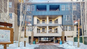 A multi-story building with balconies, a signboard, and a covered entrance. - Walk to Slopes from Cozy Condo with Pool, Hot Tub, & Fitness (Keystone)