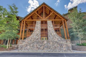 A lodge with a stone facade, wooden balconies, and a prominent entrance. - Cozy condo with shared hot tub & private deck- close to the slopes (Keystone)