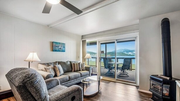 A living room with a sofa, coffee table, and a fireplace. - Lovely Lakefront Condo with  Fireplace, Free High-Speed WiFi and Stunning Views (Dillon)
