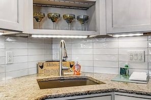 A kitchen with a sink, a soap dispenser, and a sign that reads 'Kitchen Open This Chick.' - Lovely Lakefront Condo with  Fireplace, Free High-Speed WiFi and Stunning Views (Dillon)