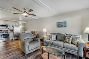 A modern living room with a sofa, armchair, and coffee table. - Lovely Lakefront Condo with  Fireplace, Free High-Speed WiFi and Stunning Views (Dillon)