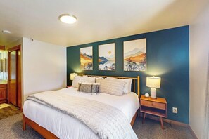 A bedroom with a bed, bedside lamps, and artwork on the wall. - Waterfront condo with full kitchen & wifi - convenient location (Dillon)