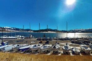 A marina with boats docked, a clear sky, and a mountainous backdrop. - Waterfront condo with full kitchen & wifi - convenient location (Dillon)