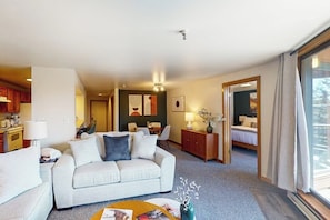 A hotel room with a sofa, a dining area, a kitchen, and a bed. - Waterfront condo with full kitchen & wifi - convenient location (Dillon)