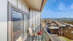 Ein Balkon mit Blick auf ein Wohngebiet und Berge.