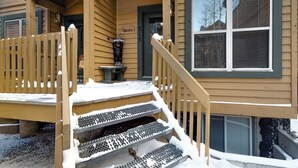 A wooden house with a porch, steps, and a window. - Inviting townhome with private hot tub, gas fireplace & deck - near skiing (Silverthorne)