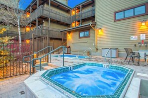 A hotel with outdoor hot tubs, a staircase, and a balcony. - Updated condo with pool, hot tubs & washer/dryer - steps from Steamboat lift (Steamboat Springs)