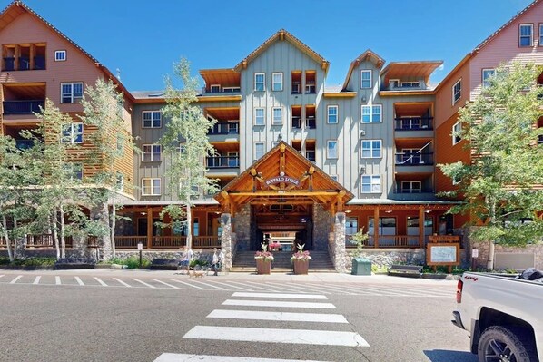 A multi-story hotel with a prominent entrance, balconies, and a crosswalk in front. - Keystone Condo w/Mountain Views, Shared Pool/Hot Tub - Near Ski Lift/Restaurants (Keystone)