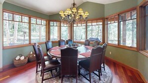 A dining room with a round table, chairs, and a chandelier. - Luxury mountain estate w/ private hot tub, home theater, two W/Ds, & spa (Keystone)