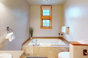 A bathroom with a bathtub, a window, a towel rack, and a toilet. - Dog-friendly Alpenglow townhome with gas fireplace, fast WiFi & great location (Steamboat Springs)