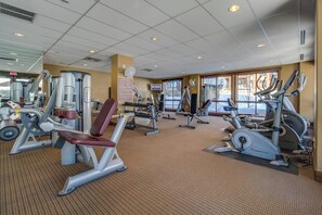 A gym with various exercise equipment, a television, and large windows. - Spacious Steamboat studio near skiing with pool, hot tubs, gym & W/D (Steamboat Springs)