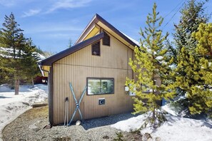 A wooden cabin with a sloped roof, a window, and a door. - Cozy mountain-view house with full kitchen, dog-friendly & convenient location (Winter Park)