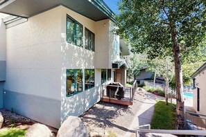 A modern two-story building with a patio area, large windows, and a tree in the foreground. - Mountain Gem Walking Distance From Slopes w/Shared Pool & Hot Tubs, Free WiFi (Snowmass)