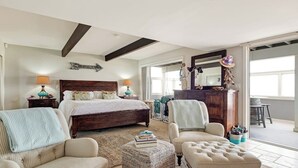 A bedroom with a bed, two chairs, a small ottoman, a dresser, and a mirror. - Beachfront home with amazing ocean views, a two-level deck, and bikes (Oceano)