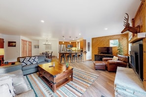 A modern living room with a sofa, a coffee table, and a fireplace. - Inviting ski-in condo with fireplace, hot tubs, & gym (Breckenridge)