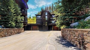 A modern two-story house with a stone facade, a garage, and a driveway. - Beautiful and Secluded Mountain Home w/ Access to Shared Amenities (Breckenridge)