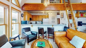 A loft-style living space with a kitchen, dining area, and seating area. - Dog-friendly condo right in the center of town - walk to & from skiing (Breckenridge)