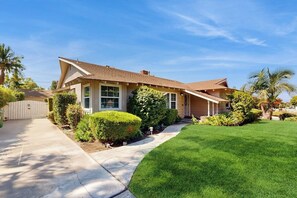 A single-story house with a sloped roof, a front porch, and a well-maintained lawn. - Charming Orange Circle home with patio, grill, & game room - near Disneyland (Orange)