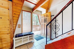 A wooden interior with a bench, a staircase, and a door leading outside. - Dog-friendly 2-story home with large deck, tree views, fireplace, & W/D (Crestline)