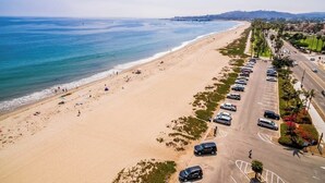 A beach with a parking lot and a road parallel to the shore. - Classic beach suite 1 block to ocean - fireplace, lovely patio, near downtown (Santa Barbara)