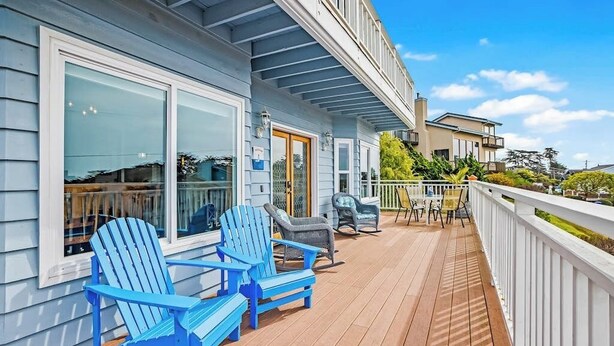A wooden deck with Adirondack chairs, a dining table, and a white railing. - Panoramic Ocean and Sunset Views with EV Charging available (Cambria)