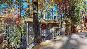 A cabin with a small porch, surrounded by trees. - Mountainside Retreat w/ Fireplace, BBQ & Furnished Deck - Near Village (Lake Arrowhead)