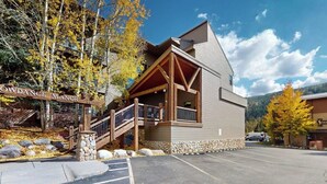 A lodge with a stone facade, wooden balcony, and a sign reading 'Crowdance Manor.' - Conveniently Located Condo with Shared Pool, Hot Tub - Walk to Slopes (Keystone)