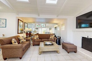 A living room with a sofa set, a coffee table, and a fireplace.