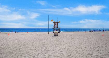 Updated 2nd-floor retreat with deck, AC, 2 car parking- steps from beach