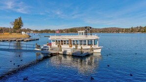 A riverboat docked at a pier with a clear view of the water and distant shoreline. - Upscale home with lake views, gas grill, washer/dryer, fireplace, patio, deck (Lake Arrowhead)
