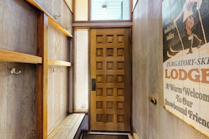 A wooden door with a grid pattern, a wooden bench, and a sign with text. - Ski-in/ski-out gem - top-floor condo - lake & mountain views, fireplace (Durango)