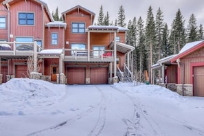 A multi-story wooden building with a covered driveway and snow-covered ground. - Beautiful townhome w/ balcony, hot tub & mountain views. Close to slopes (Keystone)