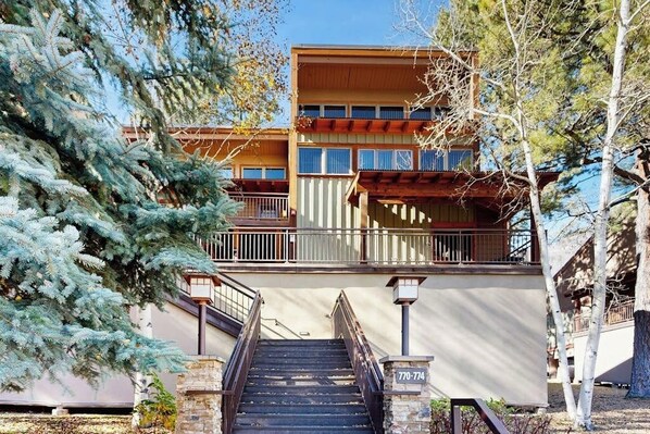 A multi-story building with a staircase leading to a balcony. - Studio condo w/ wifi, kitchenette, shared pool & hot tub - near golf & skiing (Durango)