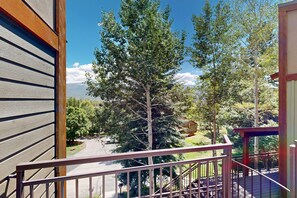 A balcony with a view of a road and trees. - Tamarron studio 18 miles north of downtown Durango, with indoor pool (Durango)