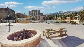 Ein Innenhof mit Feuerstelle, Picknicktisch und Blick auf die Berge.