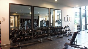 A gym with exercise equipment and mirrors. - King Bed + Queen Bed - In the Heart of Addison’s Social Scene (Addison)