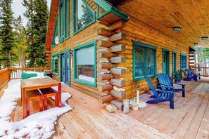 A log cabin with a porch, outdoor seating, and a fireplace. - Spacious dog-friendly cabin with fireplace, mountain view, washer/dryer, & WiFi (Fairplay)