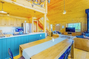 A wooden cabin interior with a kitchen, dining area, and living space. - Spacious dog-friendly cabin with fireplace, mountain view, washer/dryer, & WiFi (Fairplay)