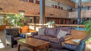 A spacious lobby with leather seating, a wooden coffee table, and a pool area. - 2nd-floor mountain-view condo with sauna, balcony, kitchen - walk to lifts (Crested Butte)