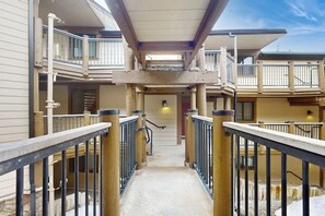 A multi-level building with a central staircase, railings, and balconies. - Ski condo with fireplace, washer/dryer, hot tubs - close to lifts & Main Street (Breckenridge)