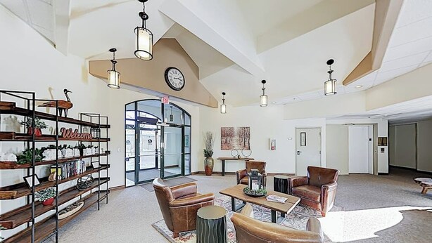 A spacious lobby with a high ceiling, a clock, a reception desk, and leather seating. - Premier Lake Dillon Condominium, 20 Min Access To 5 Resort Towns (Frisco)