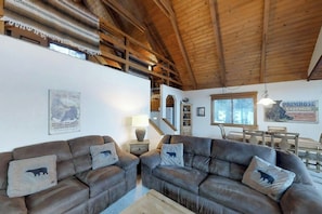 A rustic interior with wooden beams, leather sofas, and a staircase. - Mountain View Cabin with Two Private Decks, near Purgatory & Electra Lake (Durango)