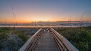 A wooden boardwalk leading to a beach with sand dunes and grasses. - Beachfront Heated Pool & Hot Tub W Mini Putt (St. Augustine)