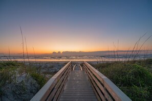 A wooden boardwalk leading to a beach with sand dunes and grasses. - Beachfront Heated Pool & Hot Tub W Mini Putt (St. Augustine)