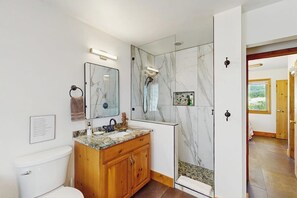 A bathroom with a marble shower, wooden vanity, and a large mirror. - Quiet home with stunning mountain views, pool table, WiFi, W/D & great location (Hesperus)