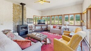 A living room with a fireplace, television, and comfortable seating.