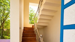 A staircase with wooden steps and metal railings leading to an upper floor.