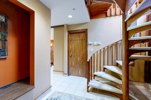 A staircase with wooden railings and a handrail, leading to an upper floor. - Cozy condo with private washer and dryer, on-site golf, share pool and hot tub (Durango)